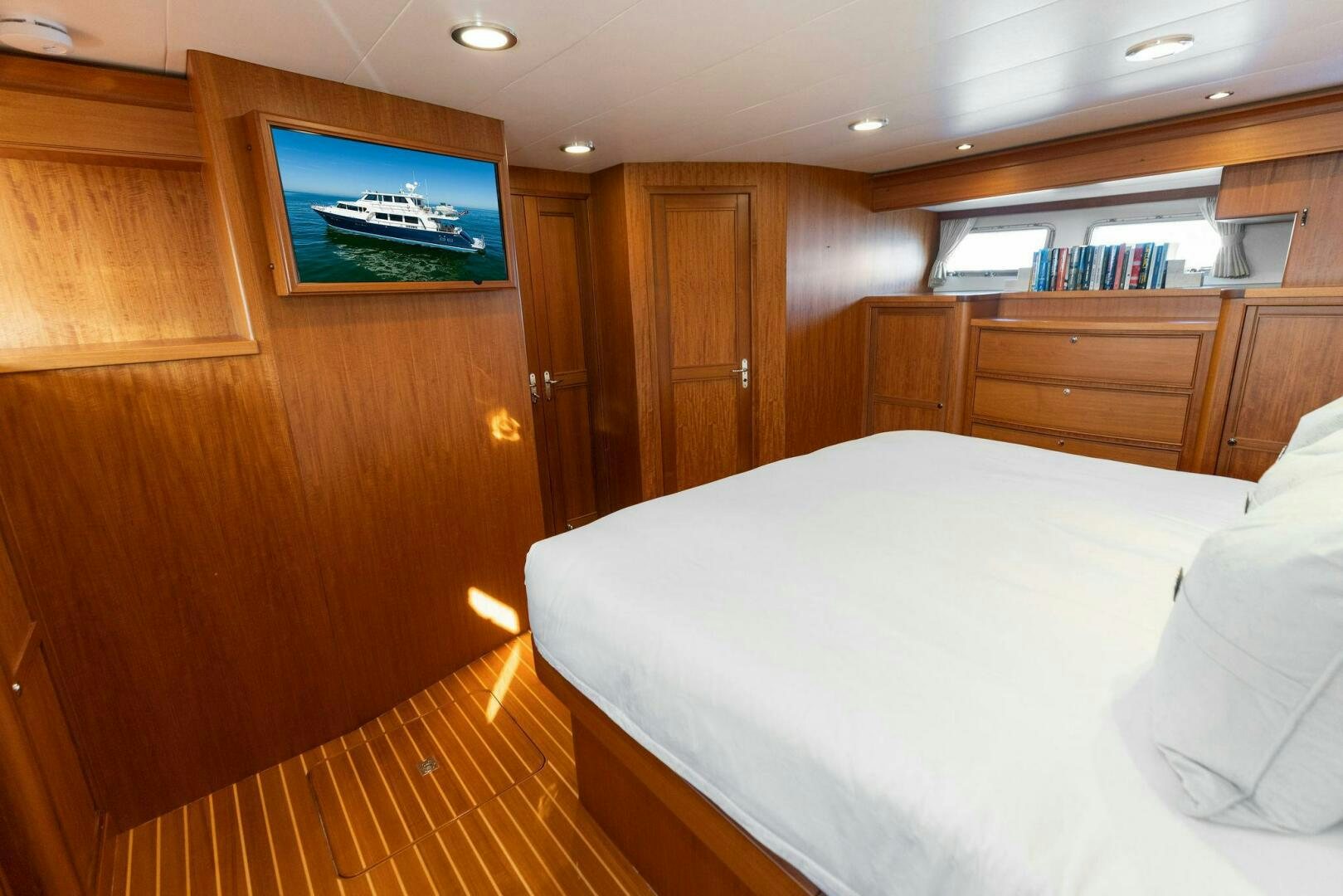 a room with a bed and a television aboard SUNZSET Yacht for Sale