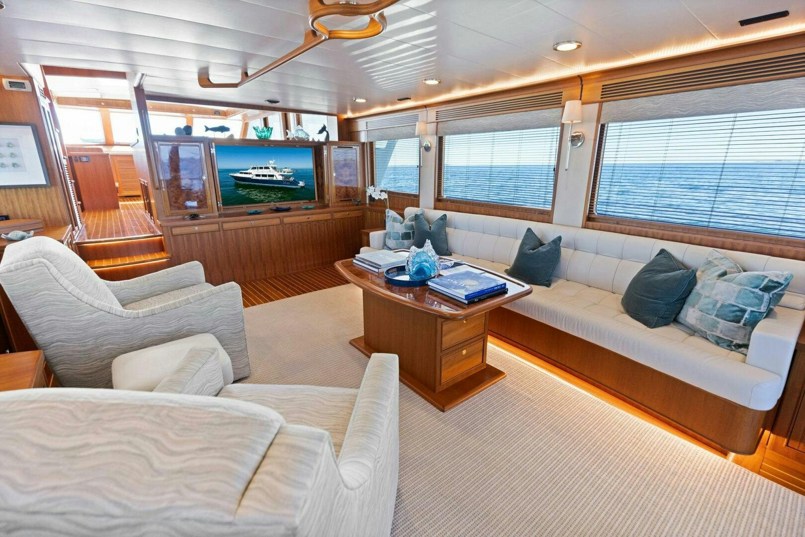 a living room with a large television aboard SUNZSET Yacht for Sale