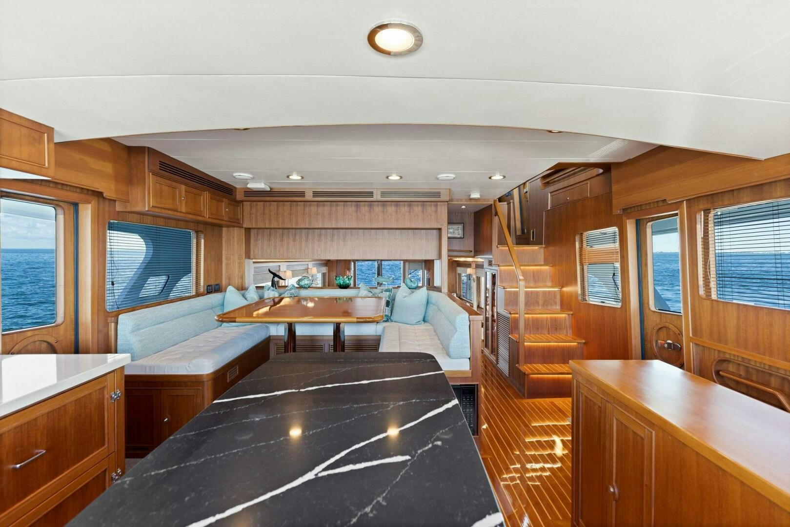 a room with a table and couch aboard SUNZSET Yacht for Sale