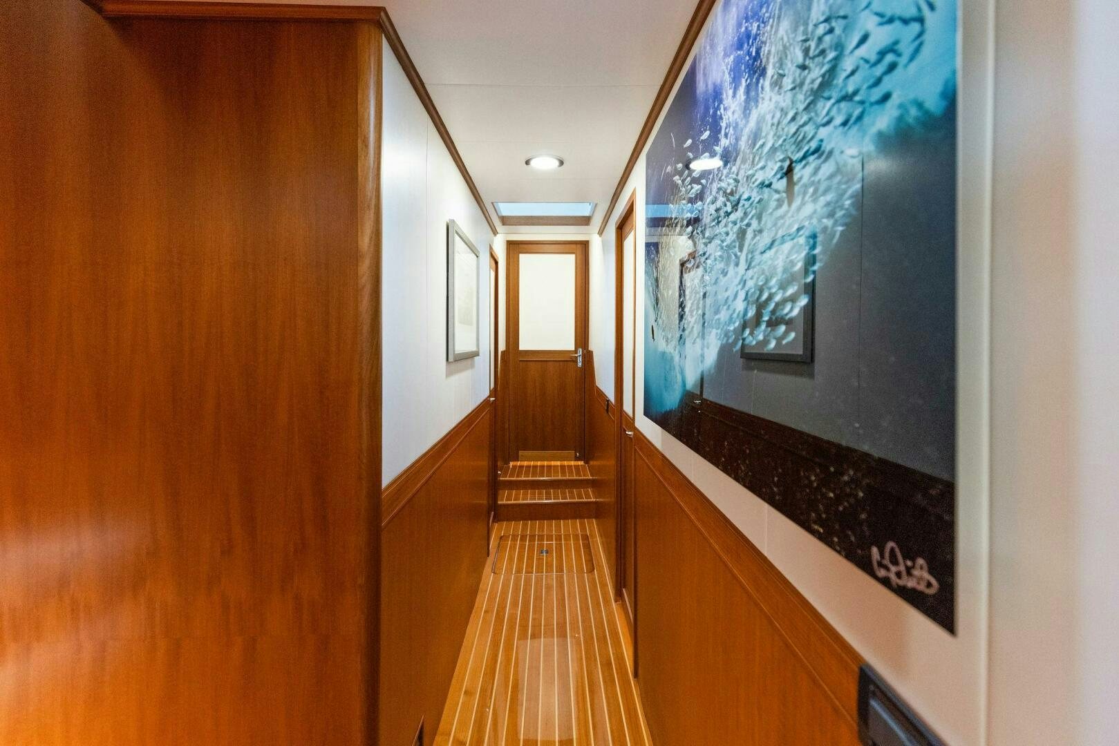 a hallway with a painting on the wall aboard SUNZSET Yacht for Sale