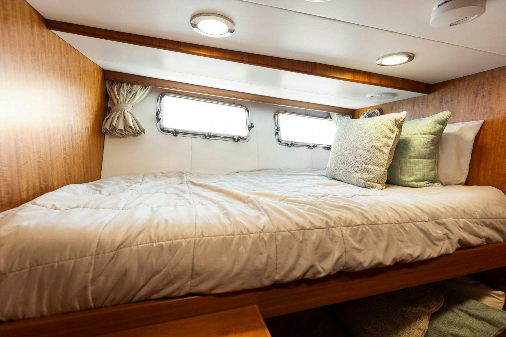 a bed with a wooden headboard aboard SUNZSET Yacht for Sale