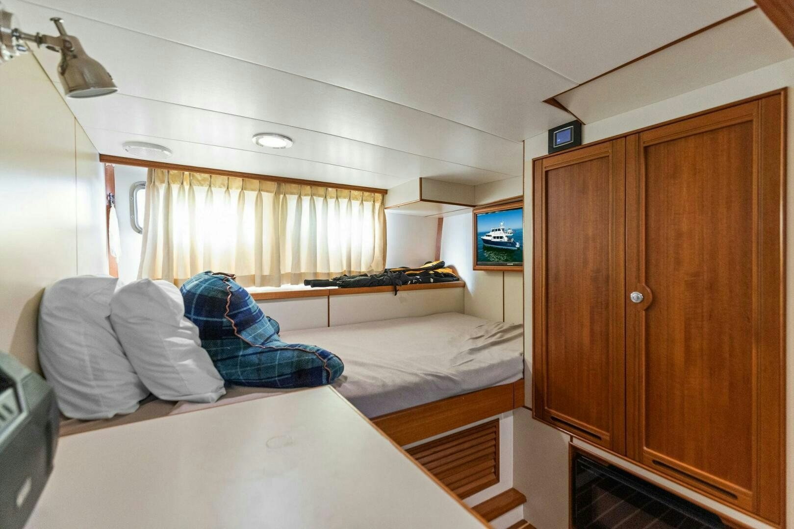 a bedroom with a bed and a desk aboard SUNZSET Yacht for Sale