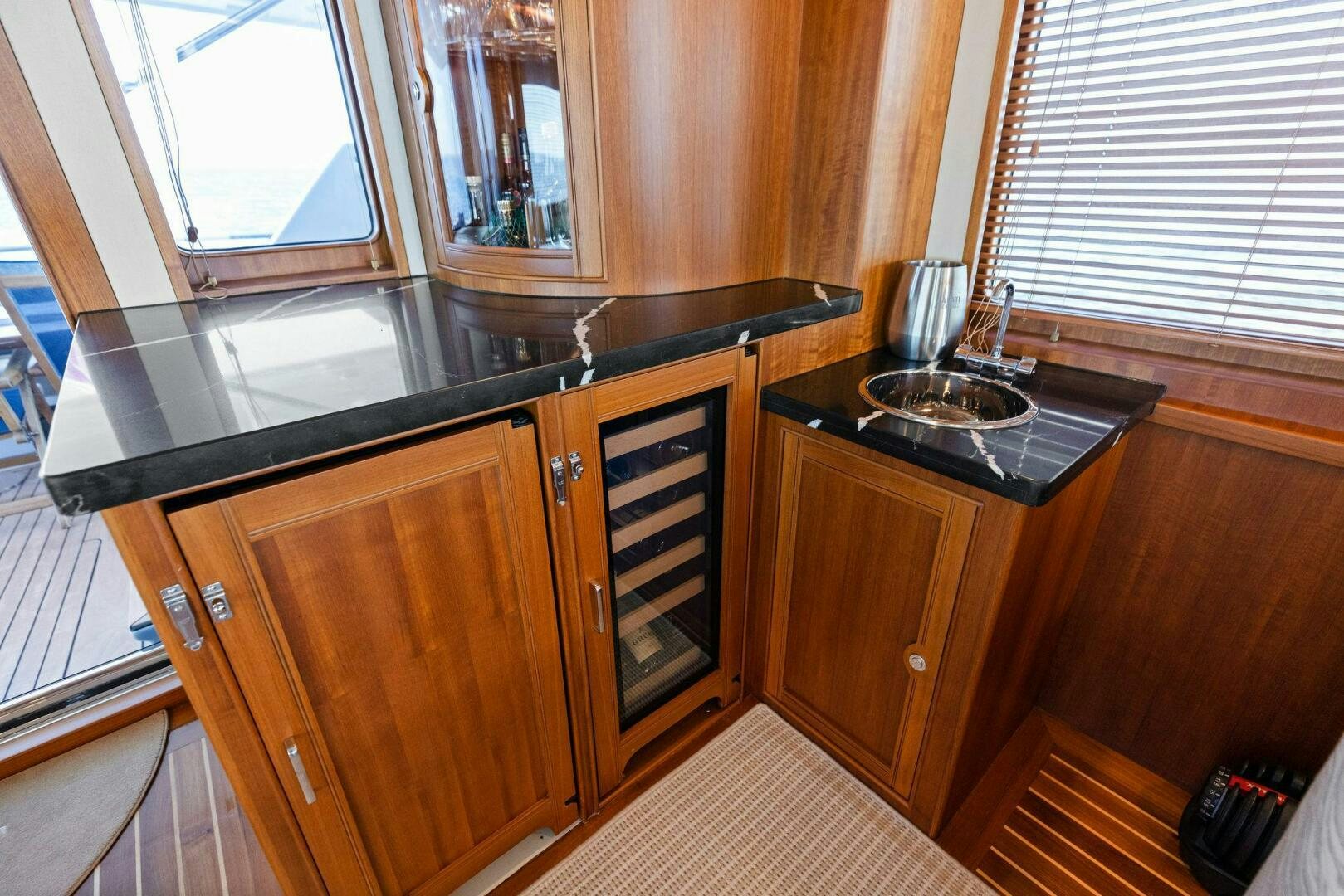 a kitchen with wooden cabinets aboard SUNZSET Yacht for Sale