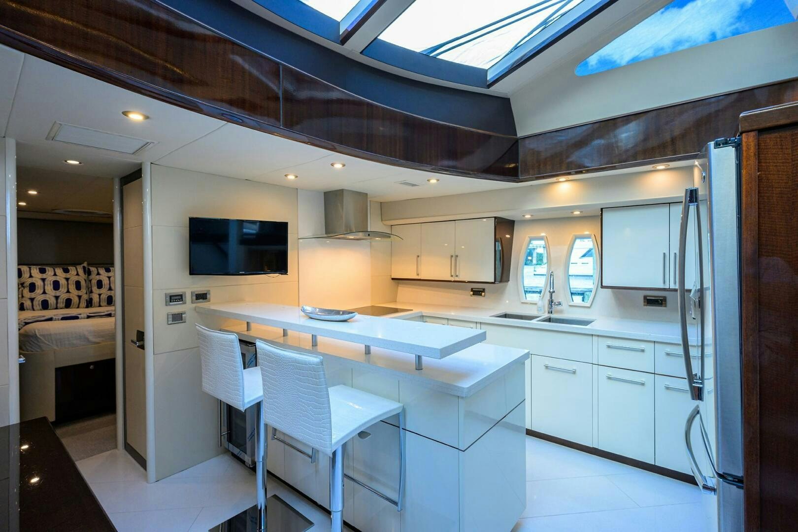 a kitchen with white cabinets aboard VIXEN Yacht for Sale