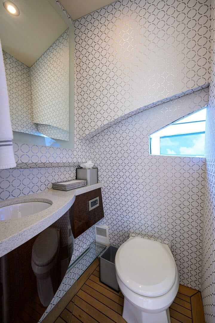 a bathroom with a toilet and a sink aboard VIXEN Yacht for Sale