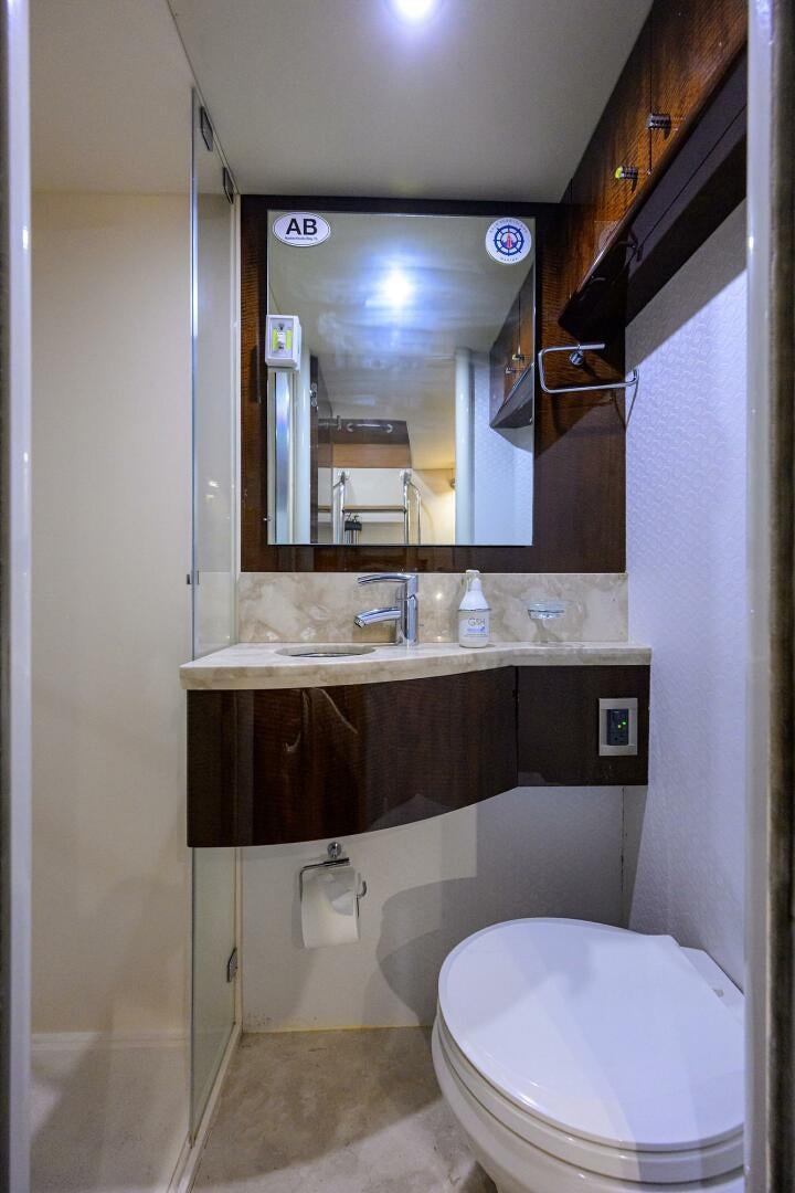 a bathroom with a toilet and a sink aboard VIXEN Yacht for Sale
