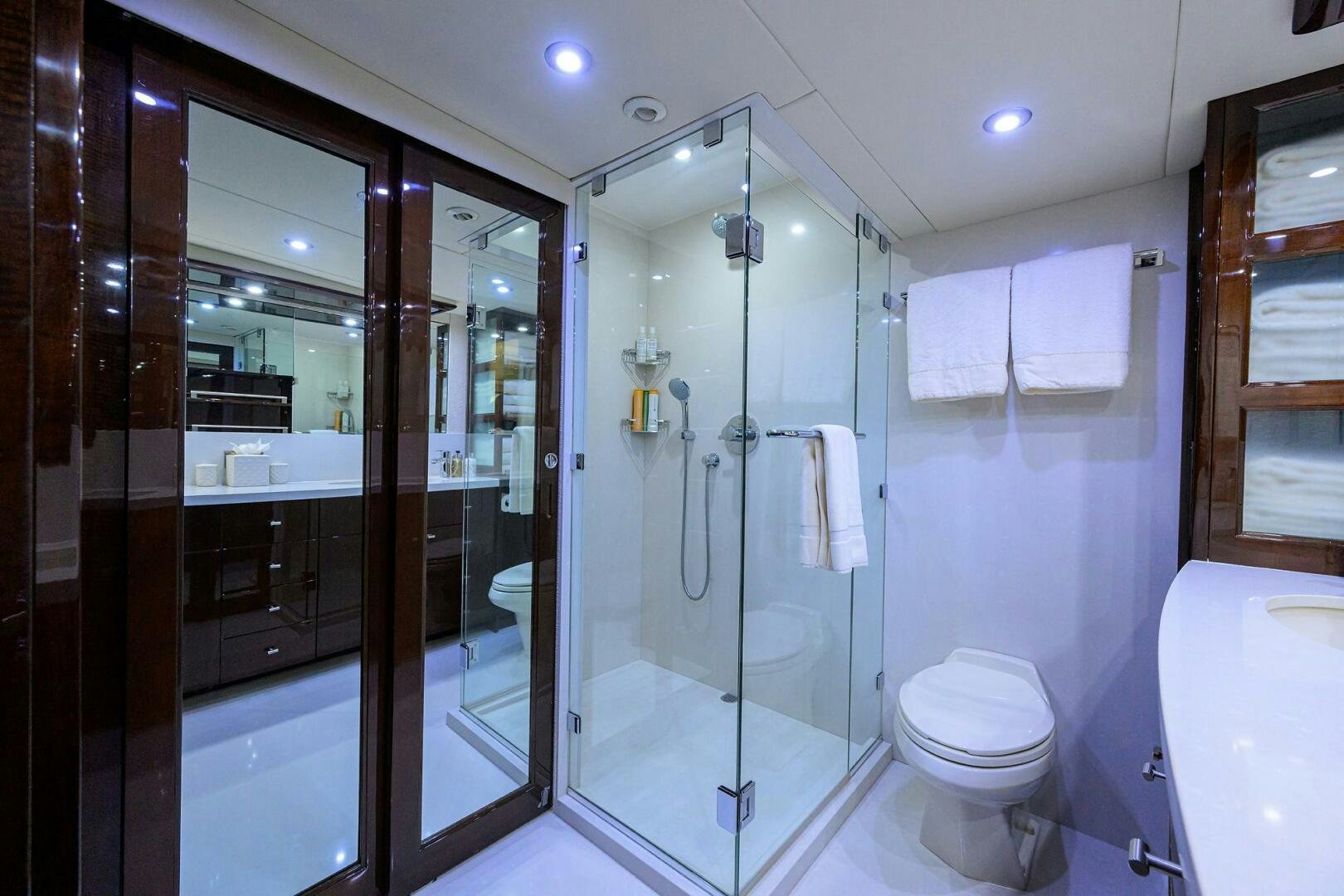 a bathroom with a glass shower aboard VIXEN Yacht for Sale