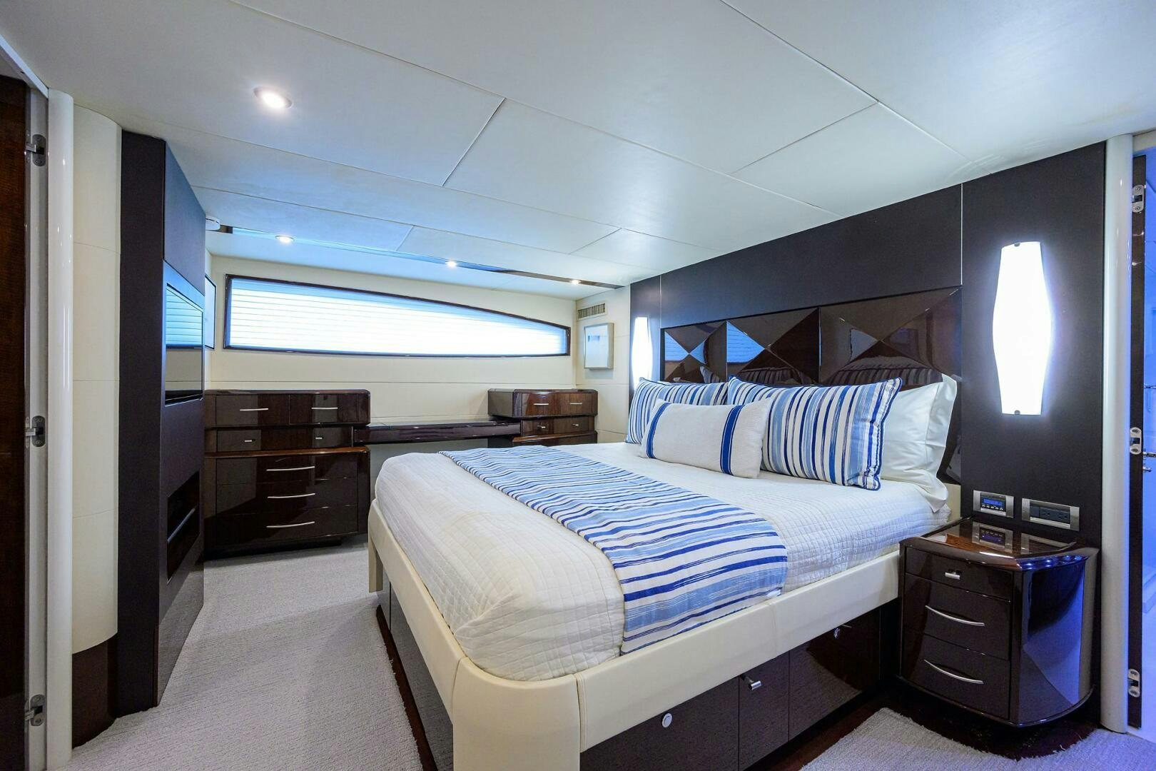 a bedroom with a bed and a desk aboard VIXEN Yacht for Sale