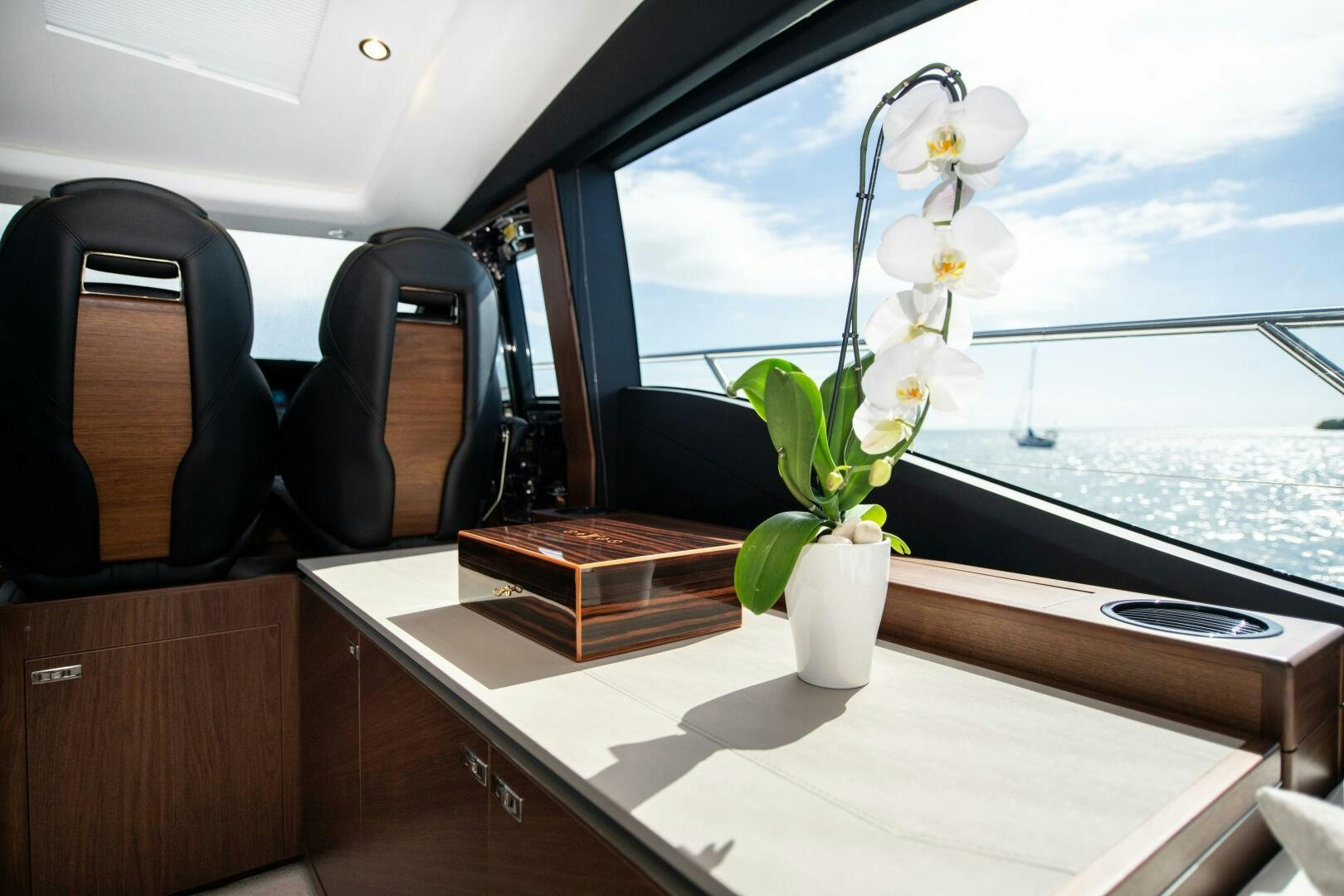 a room with a window and a vase with flowers in it aboard LADY D Yacht for Sale