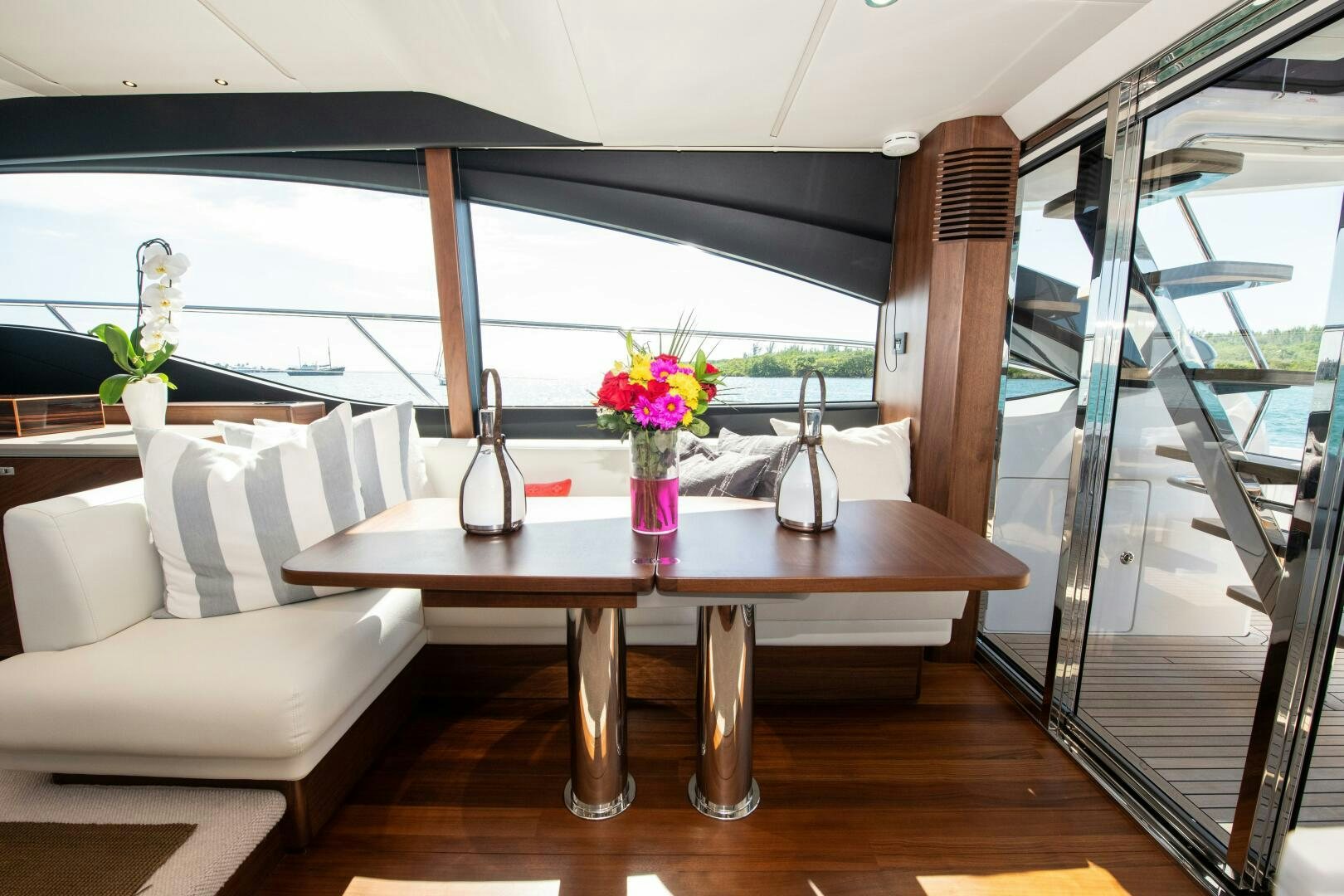 a table with a vase of flowers on it aboard LADY D Yacht for Sale