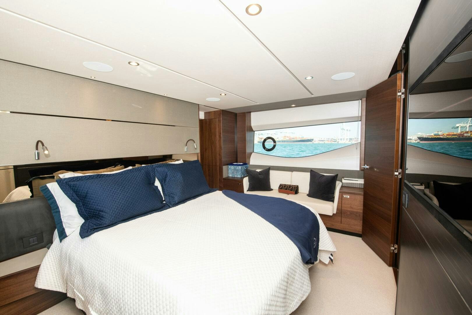 a room with a bed and a large window aboard LADY D Yacht for Sale