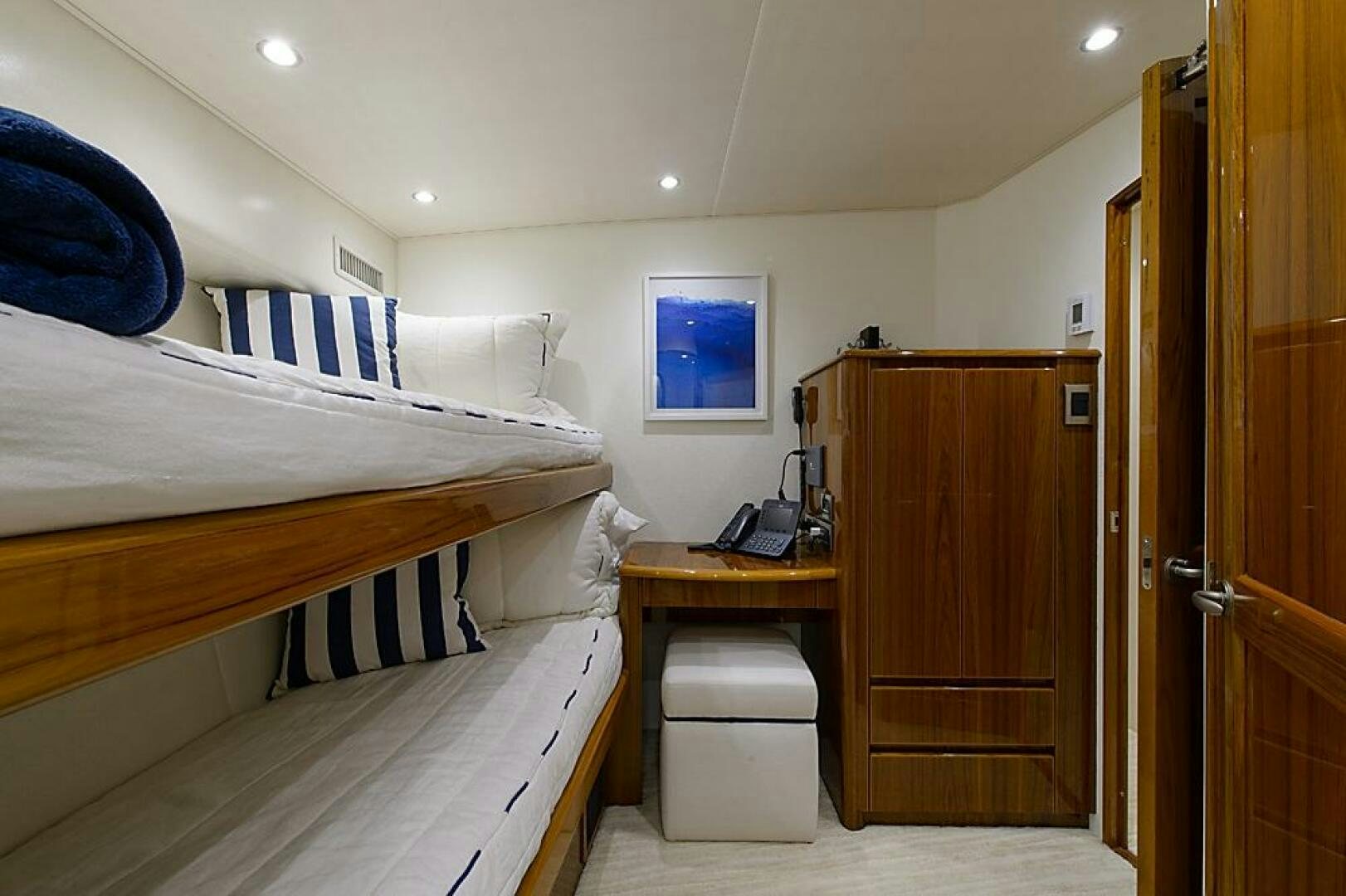 a room with a bed and desk aboard ASASKA Yacht for Sale