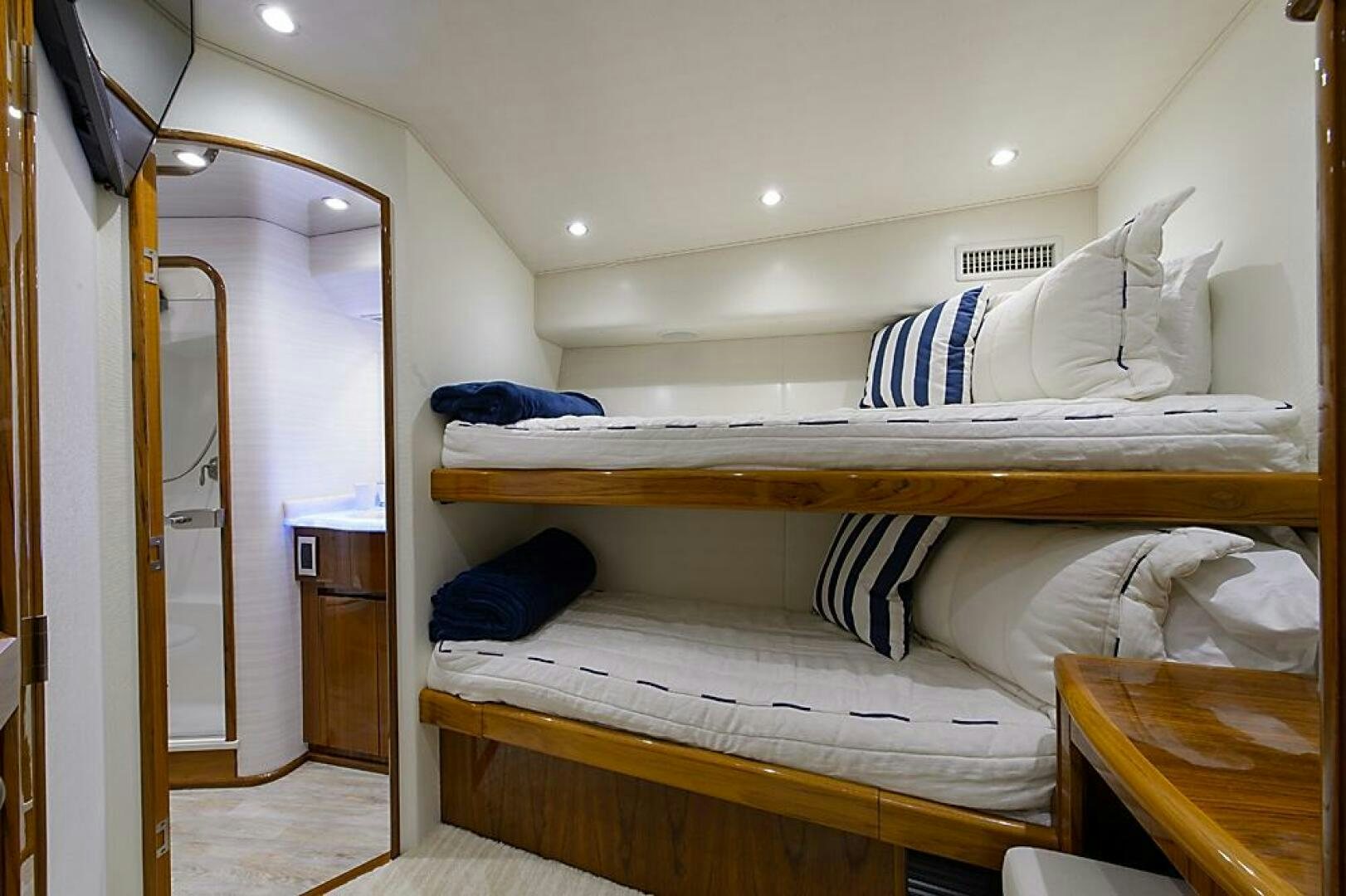 a room with beds and a desk aboard ASASKA Yacht for Sale