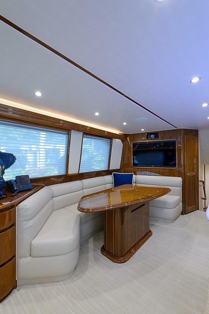 a room with a table and a couch aboard ASASKA Yacht for Sale
