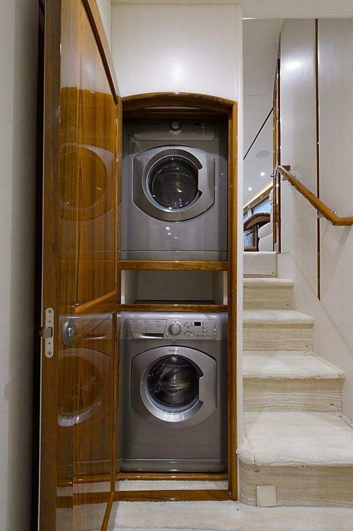 a washer and dryer in a room aboard ASASKA Yacht for Sale