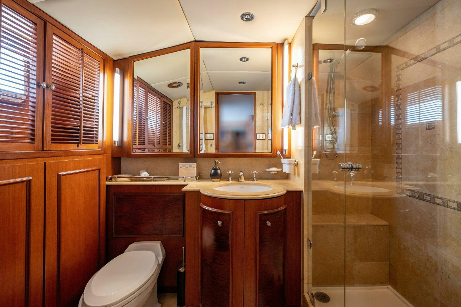 a bathroom with a glass shower aboard TRILOGY Yacht for Sale