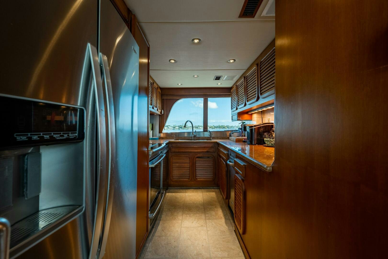 a large kitchen with a large glass door aboard TRILOGY Yacht for Sale