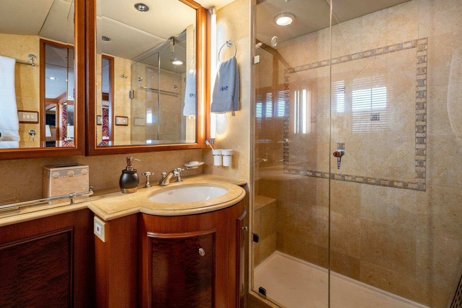 a bathroom with a glass shower aboard TRILOGY Yacht for Sale