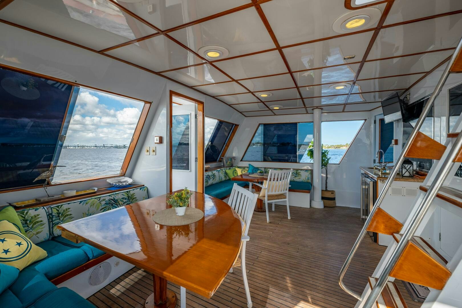 a room with a table and chairs aboard TRILOGY Yacht for Sale