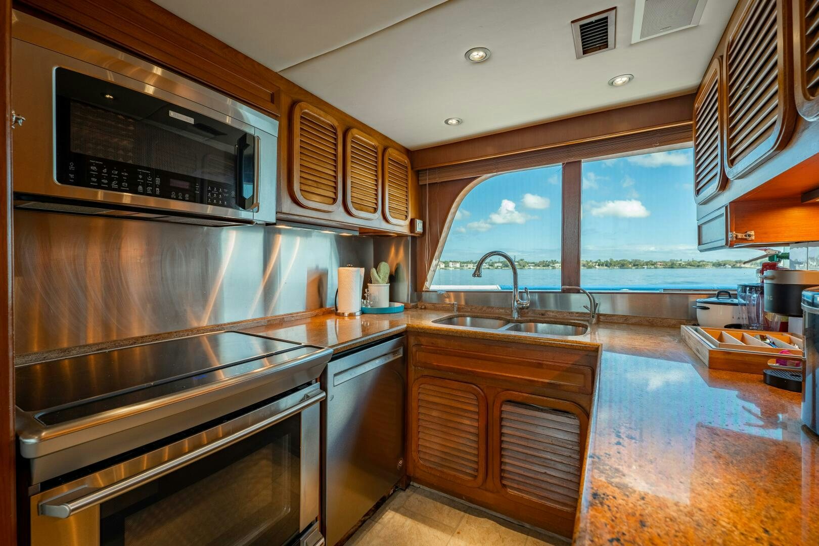 a kitchen with wooden cabinets aboard TRILOGY Yacht for Sale