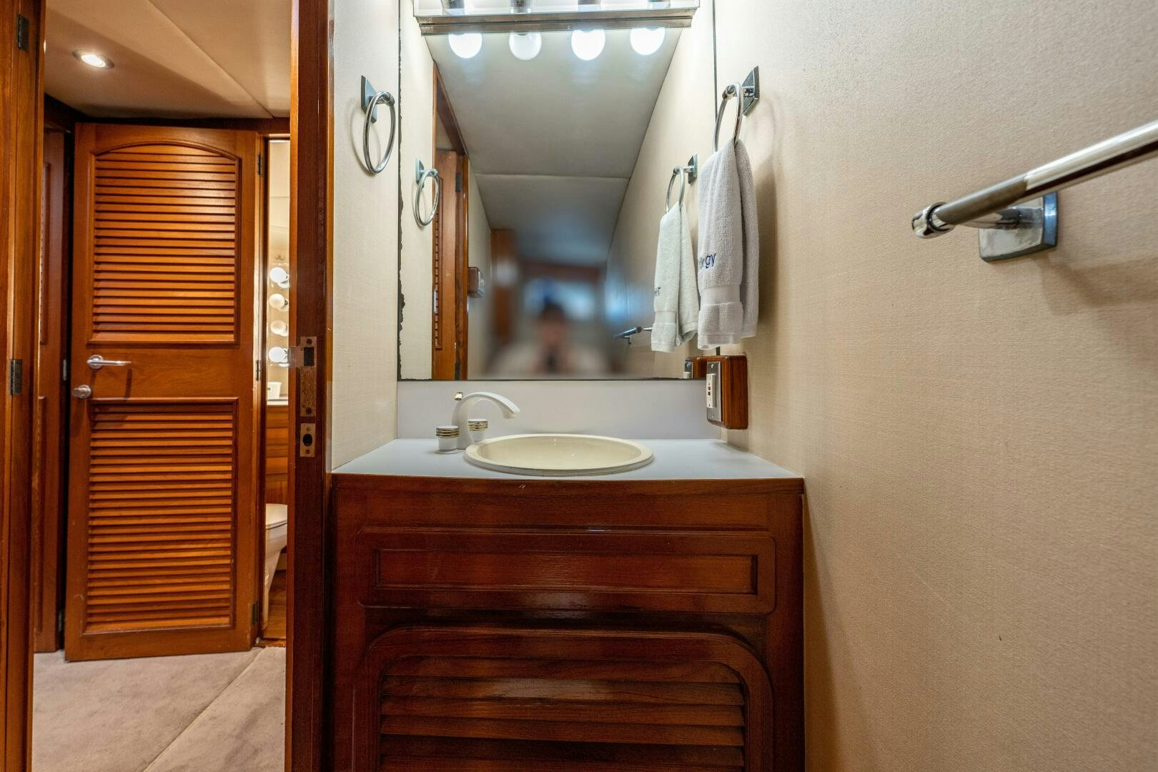 a bathroom with a sink and a mirror aboard TRILOGY Yacht for Sale