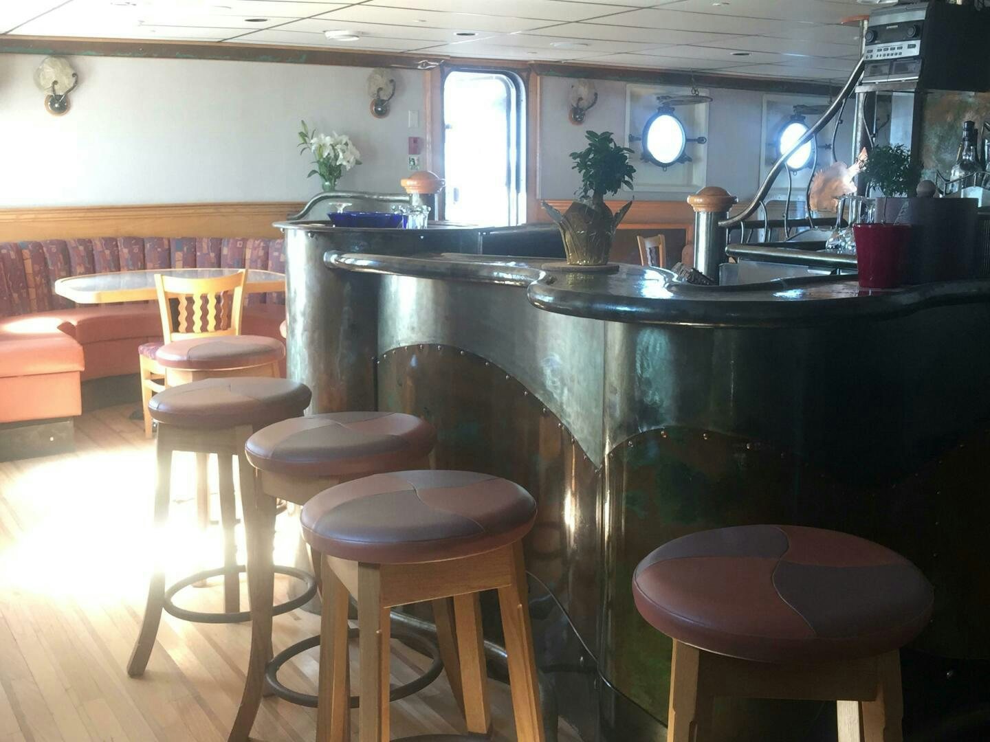 a kitchen with stools and a bar aboard SALTY Yacht for Sale