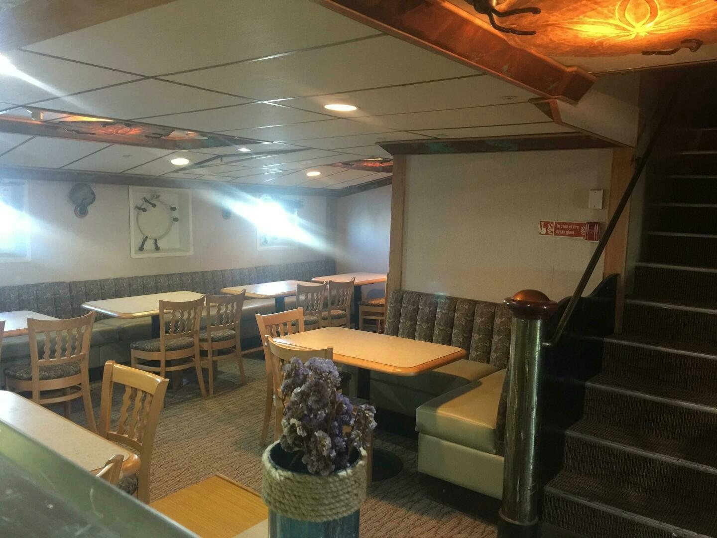 a room with tables and chairs aboard SALTY Yacht for Sale