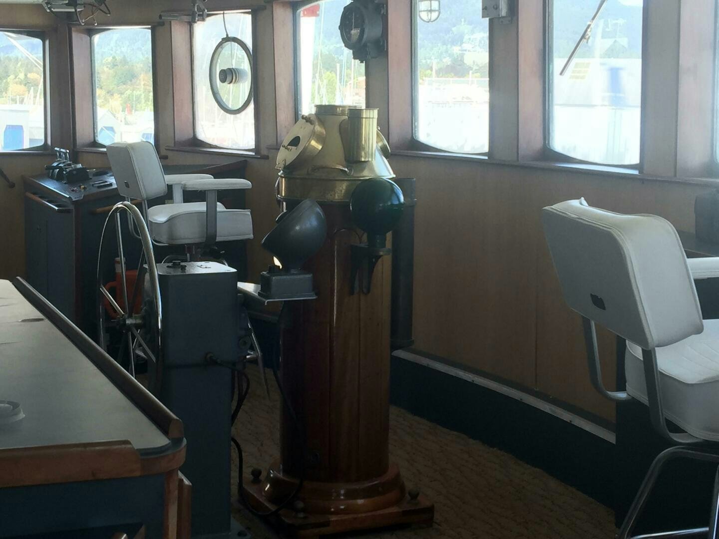 a room with a machine and chairs aboard SALTY Yacht for Sale
