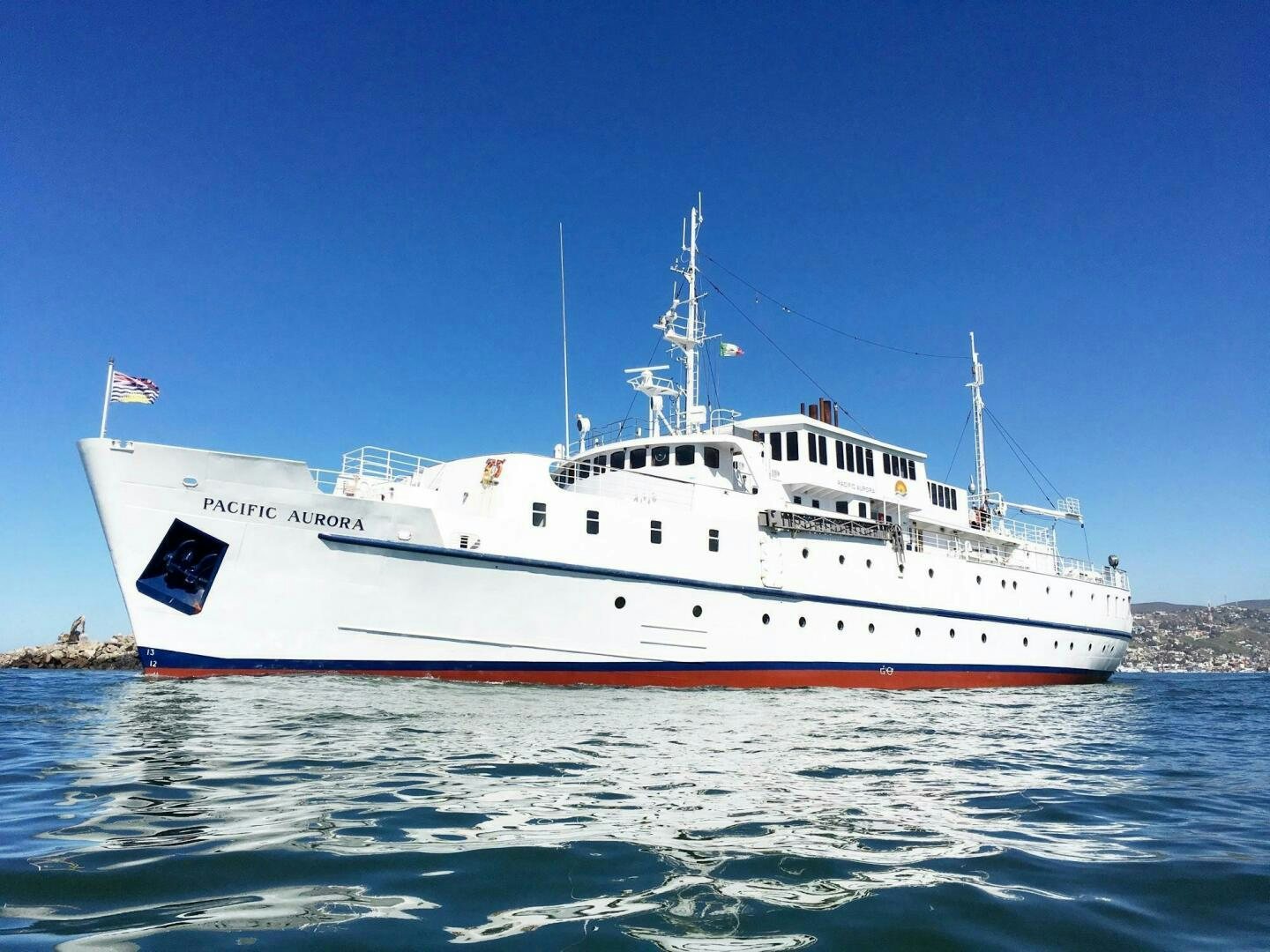 a large white ship in the water aboard SALTY Yacht for Sale