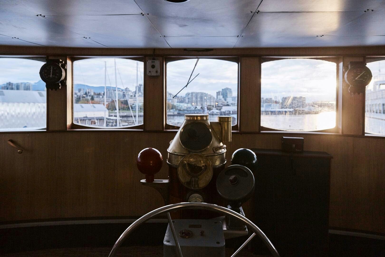 a room with a large window and a metal object on the wall aboard SALTY Yacht for Sale
