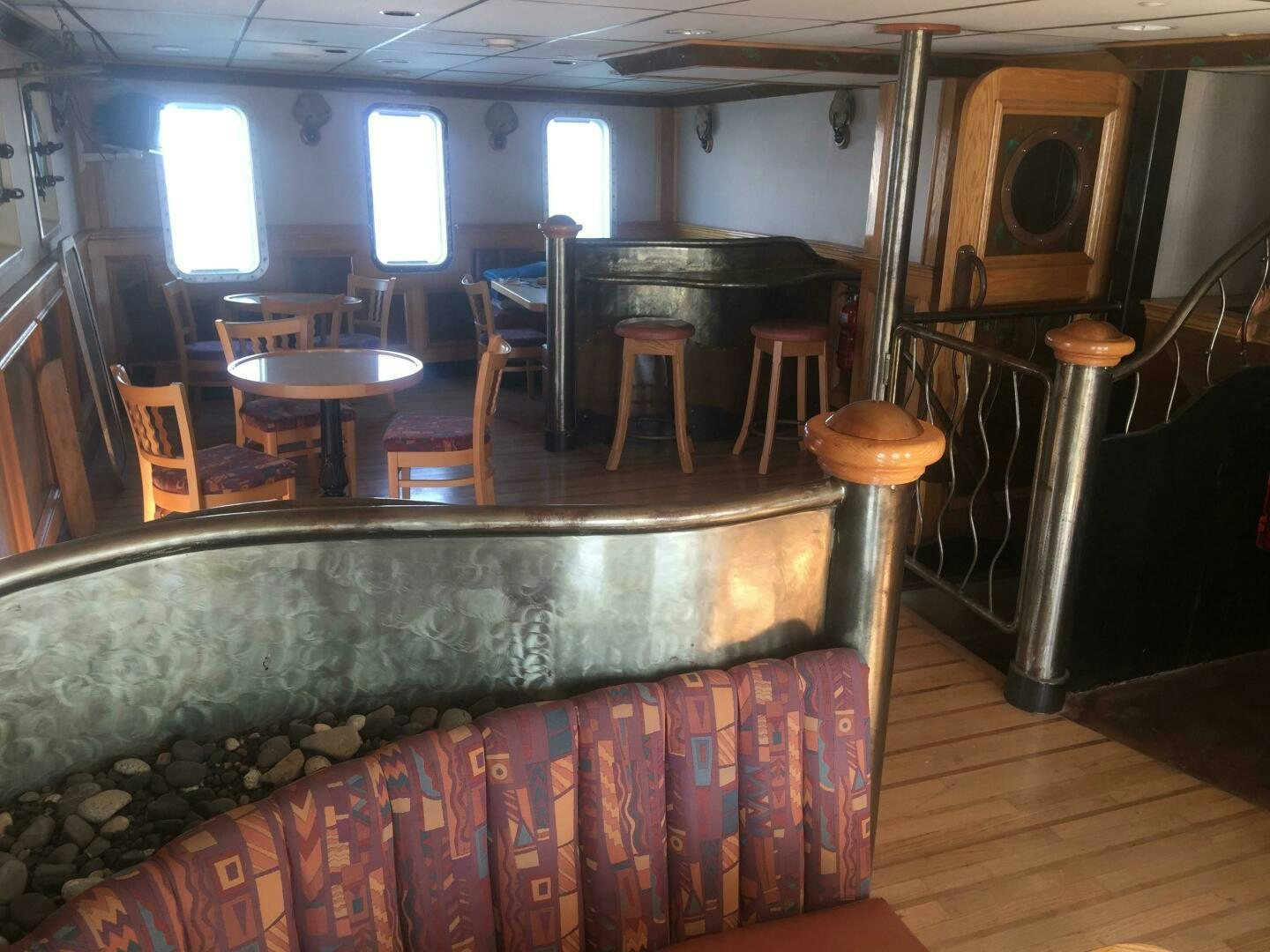 a room with a couch and stools aboard SALTY Yacht for Sale