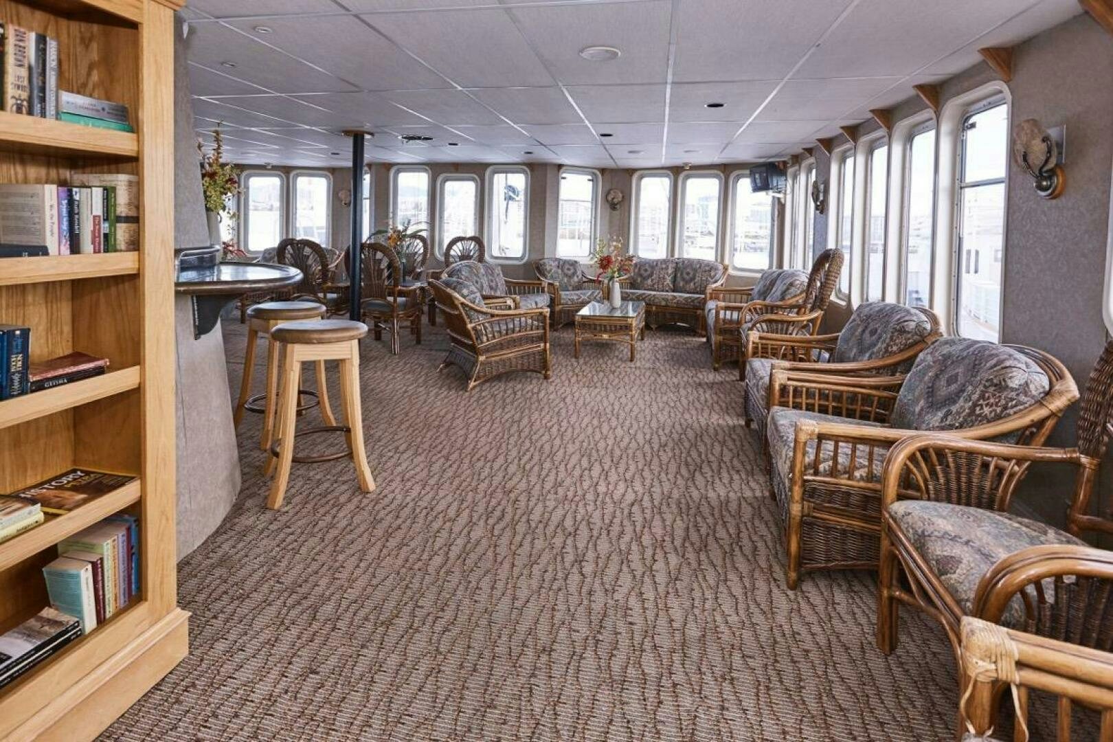 a room with many chairs and tables aboard SALTY Yacht for Sale