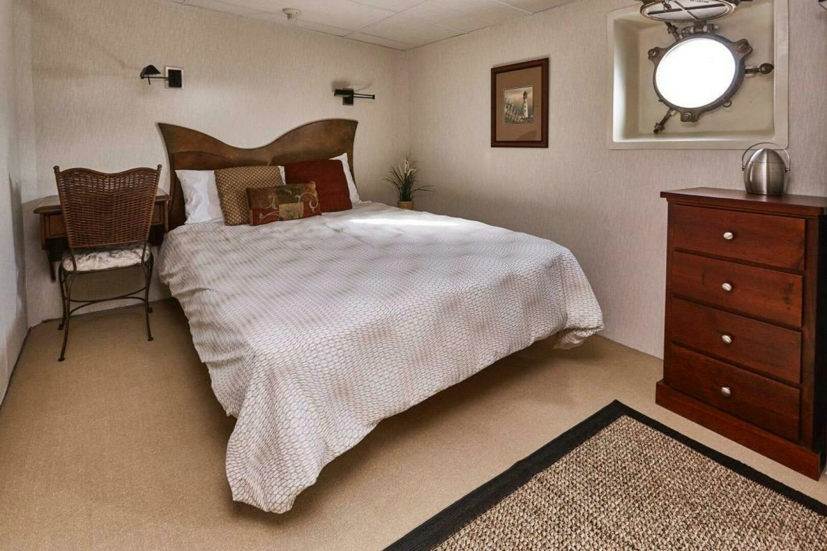 a bed with a white comforter aboard SALTY Yacht for Sale