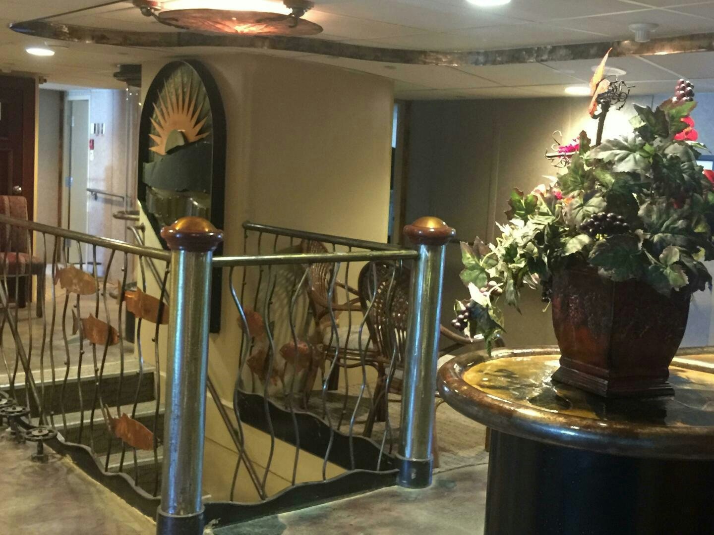 a room with a fountain and potted plants aboard SALTY Yacht for Sale