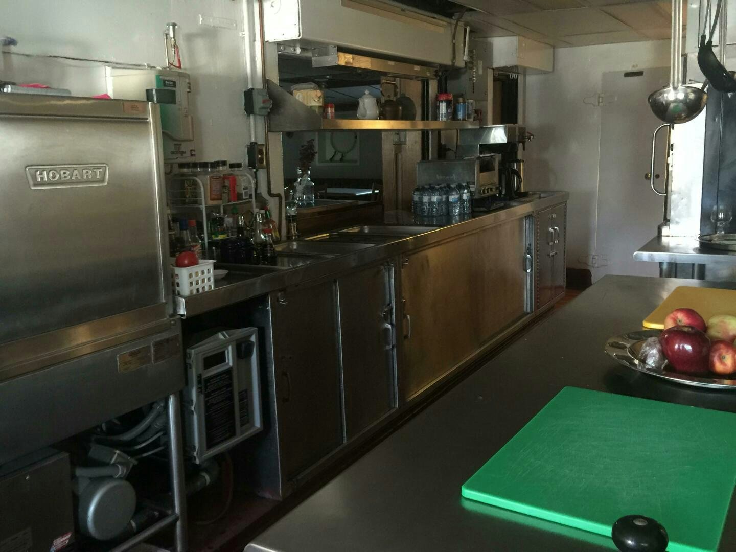 a kitchen with a green table aboard SALTY Yacht for Sale