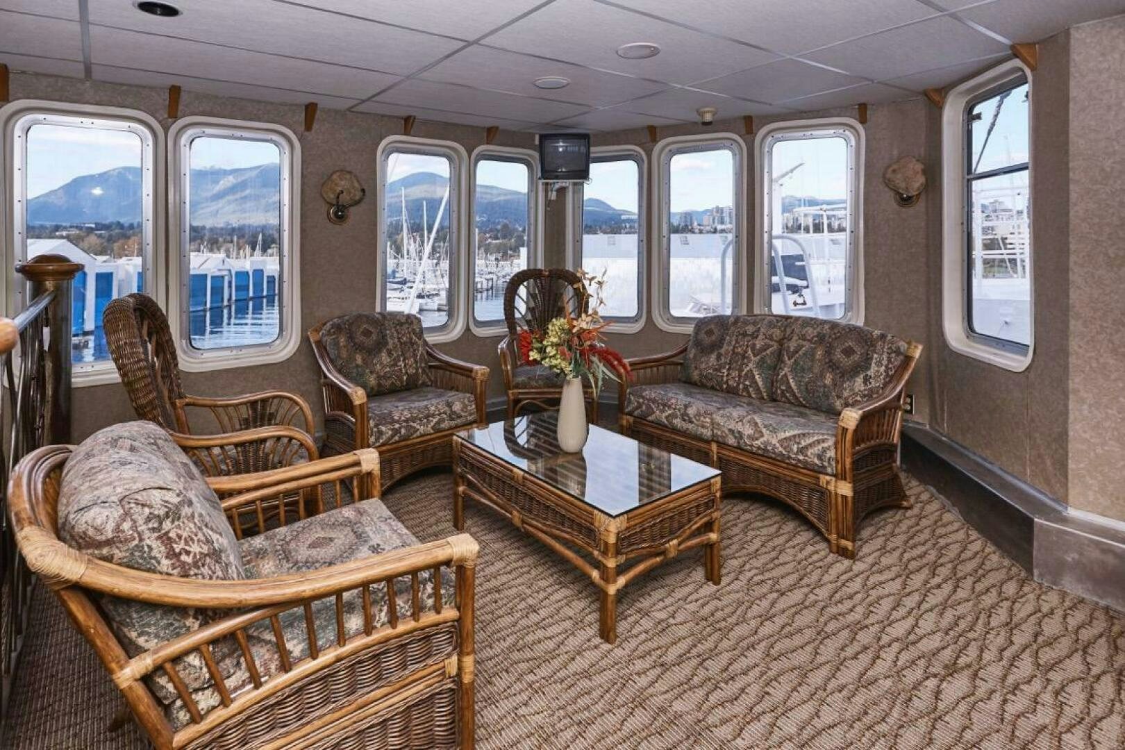 a living room with chairs and a table aboard SALTY Yacht for Sale