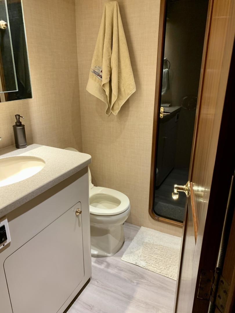 a bathroom with a toilet and sink aboard OBSESSION Yacht for Sale