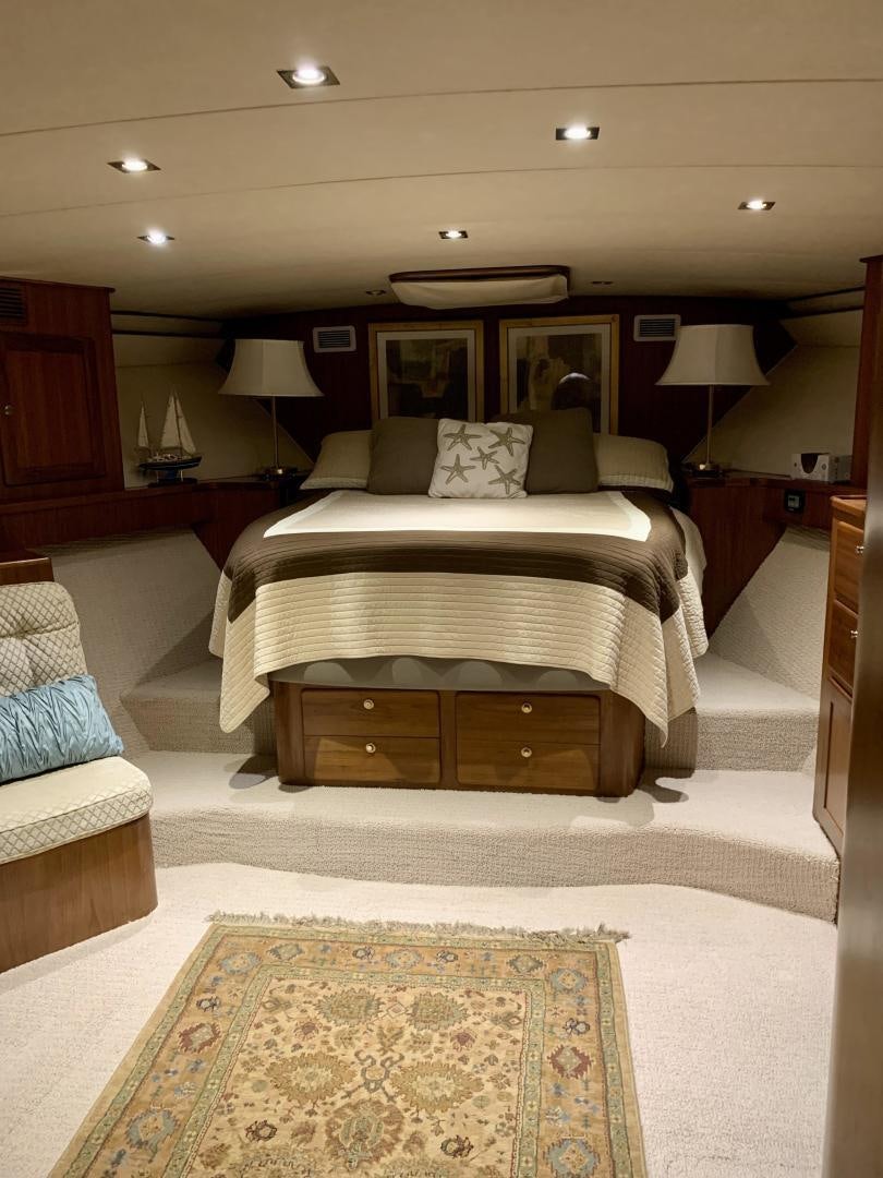 a bedroom with a bed and a couch aboard OBSESSION Yacht for Sale