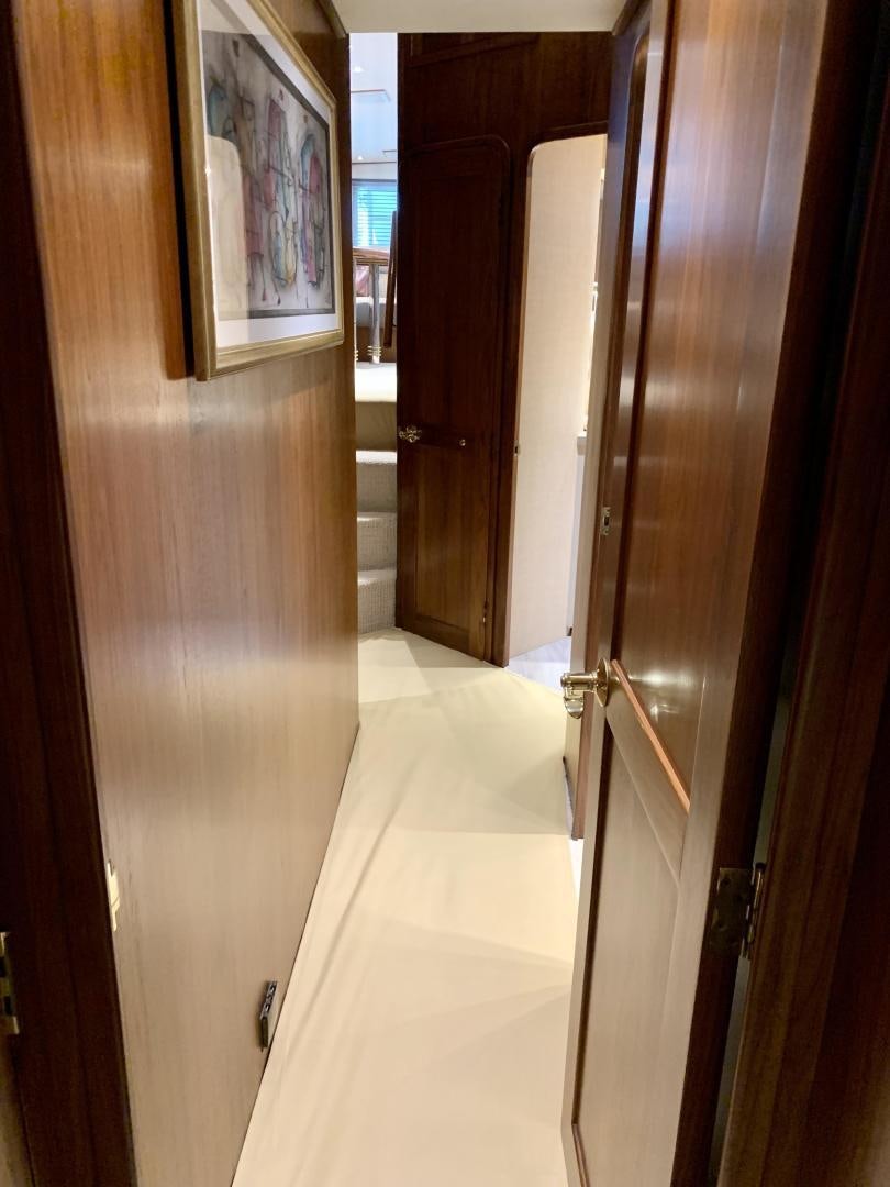 a hallway with wood doors aboard OBSESSION Yacht for Sale