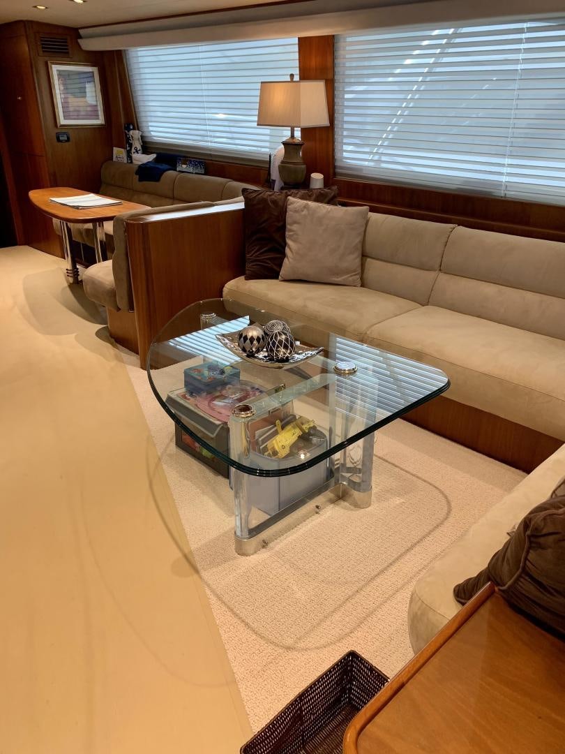 a living room with a couch and coffee table aboard OBSESSION Yacht for Sale