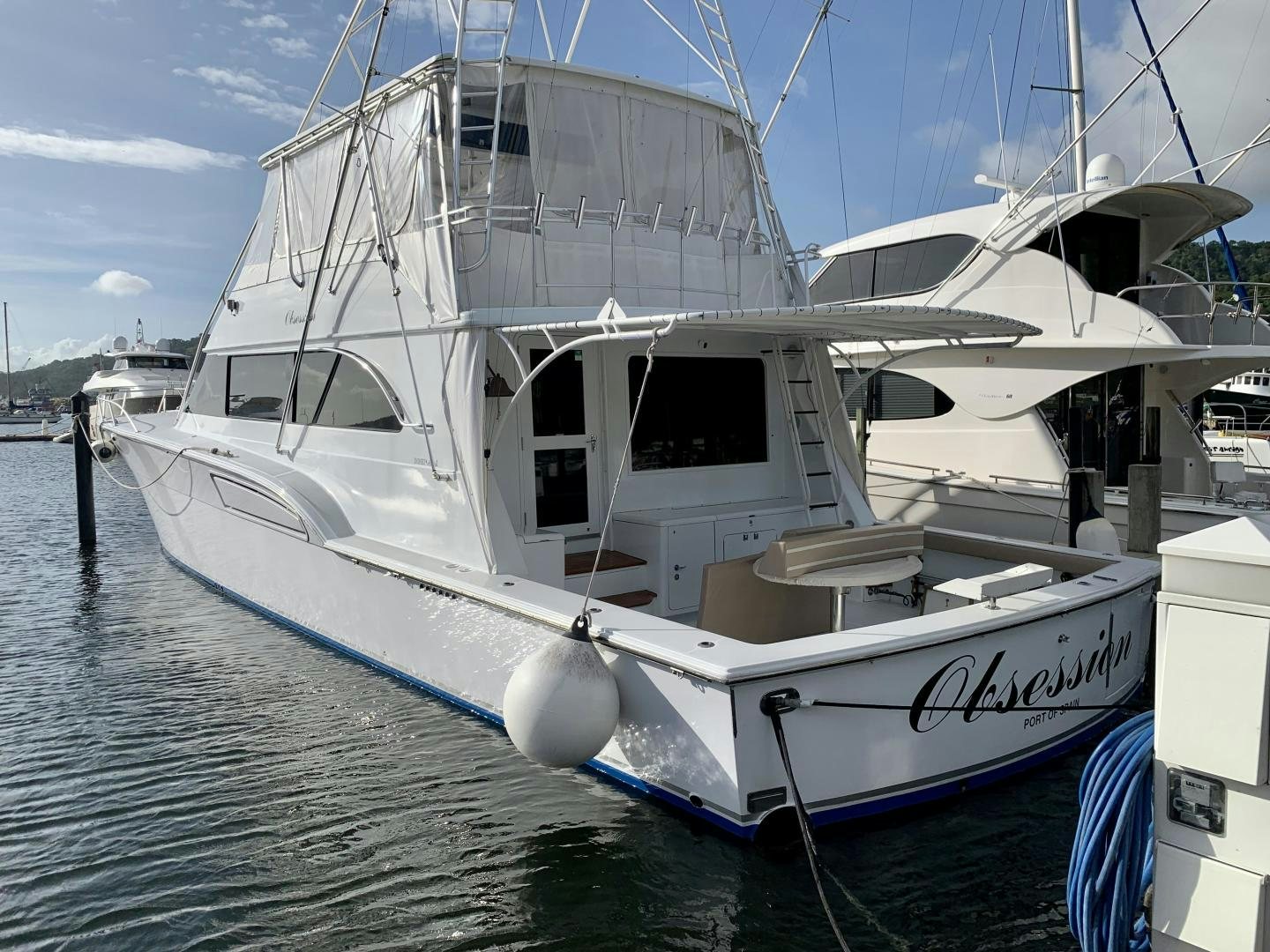 a white boat in the water aboard OBSESSION Yacht for Sale