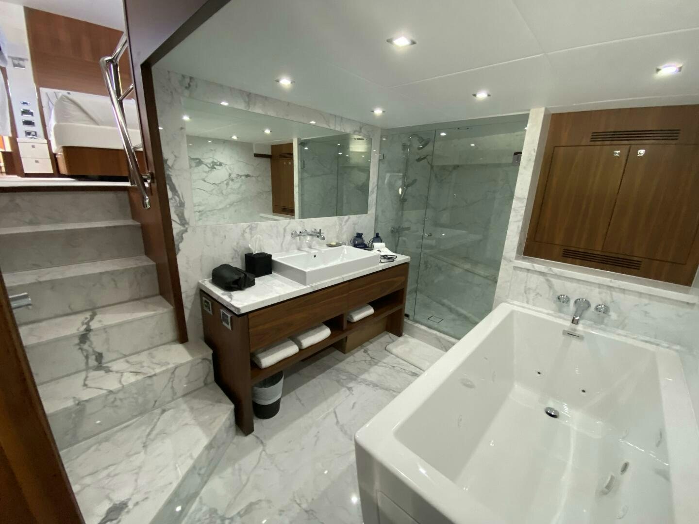 a bathroom with a tub sink and a mirror aboard SEAHORSE Yacht for Sale