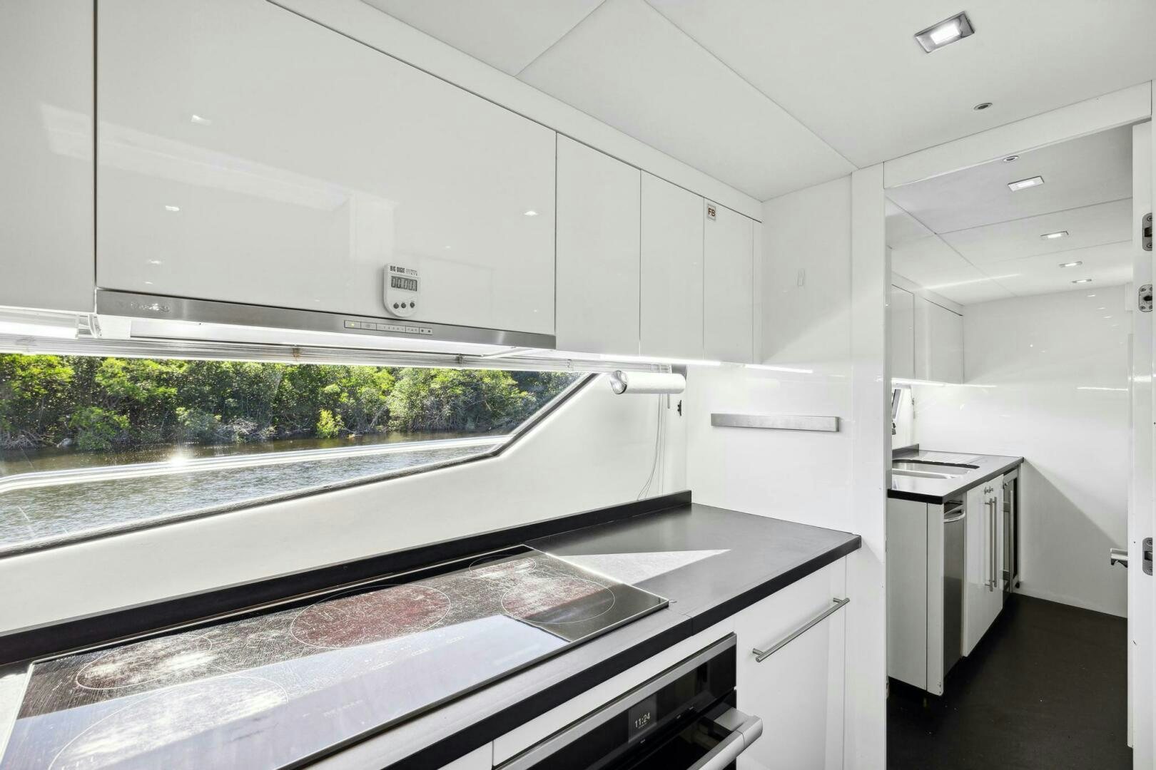 a kitchen with white cabinets aboard SEAHORSE Yacht for Sale