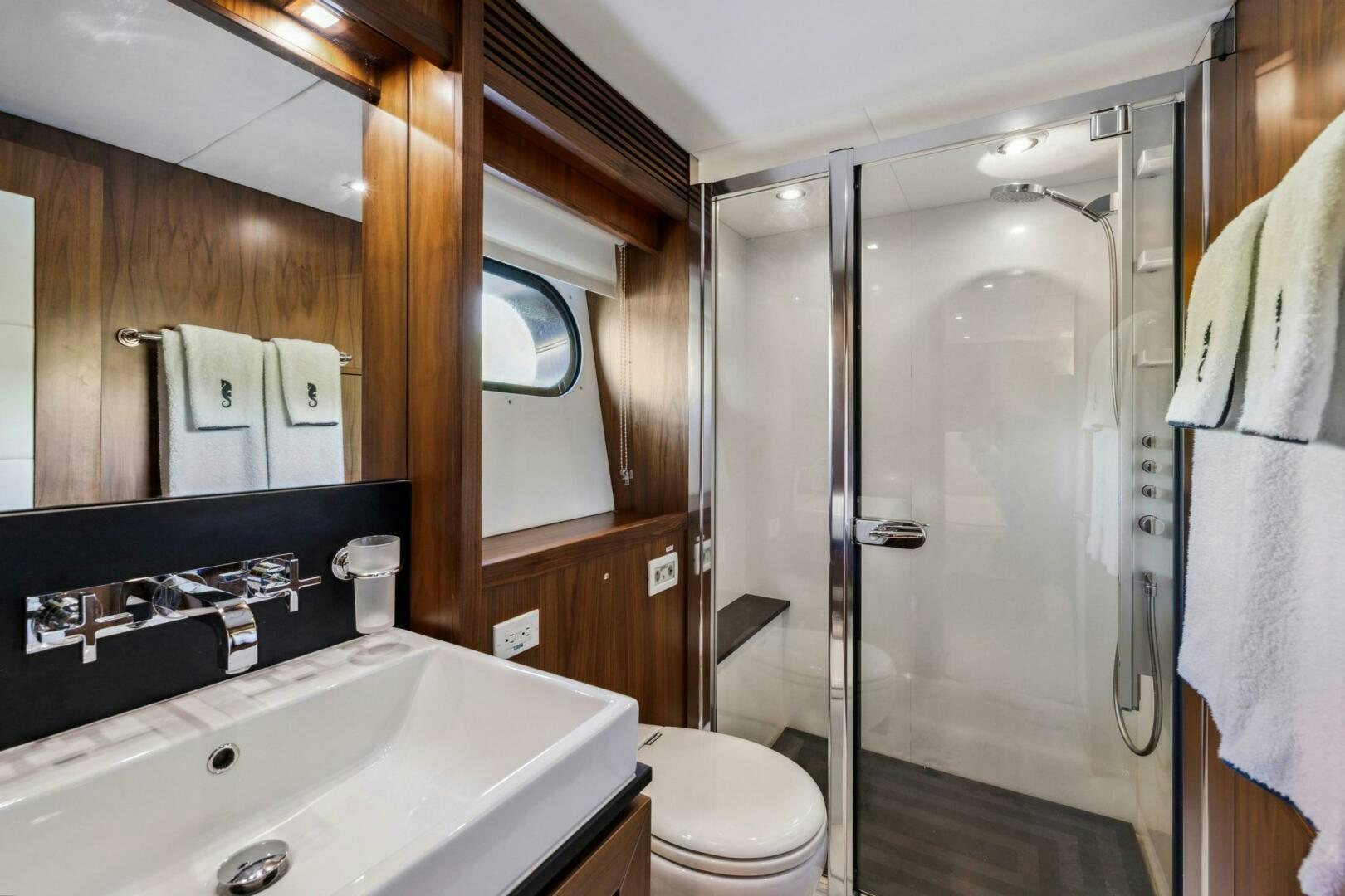 a bathroom with a sink toilet and a shower unit aboard SEAHORSE Yacht for Sale