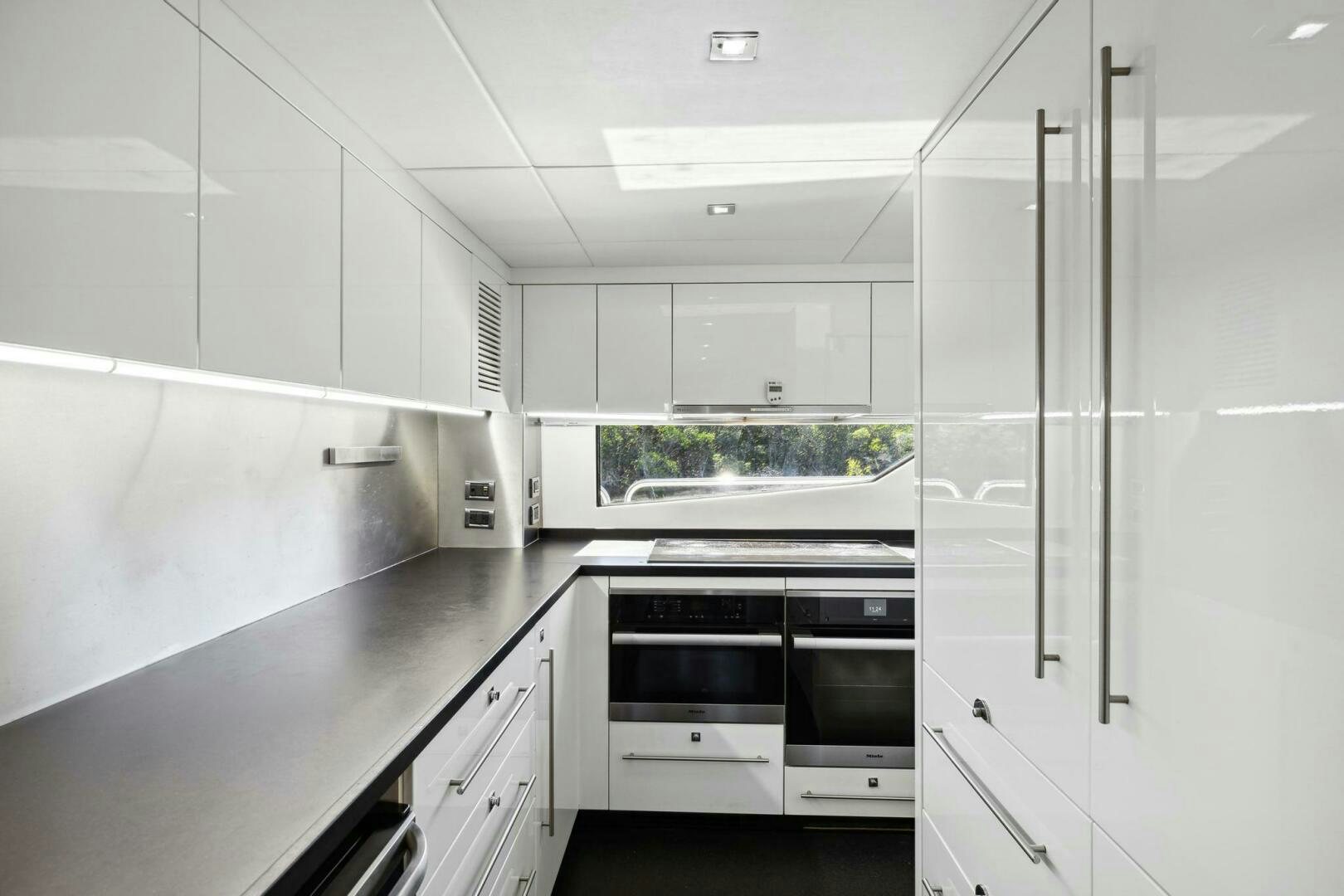 a kitchen with white cabinets aboard SEAHORSE Yacht for Sale