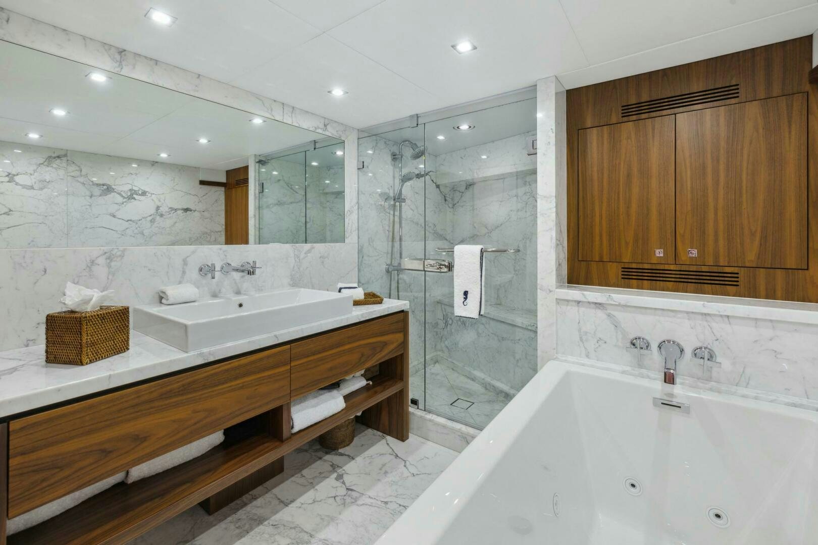 a bathroom with a bathtub and sinks aboard SEAHORSE Yacht for Sale