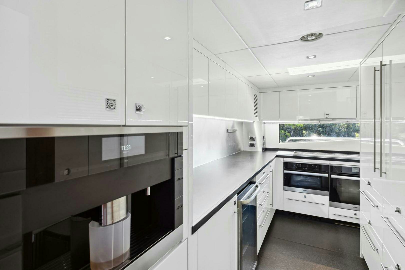 a kitchen with white cabinets aboard SEAHORSE Yacht for Sale