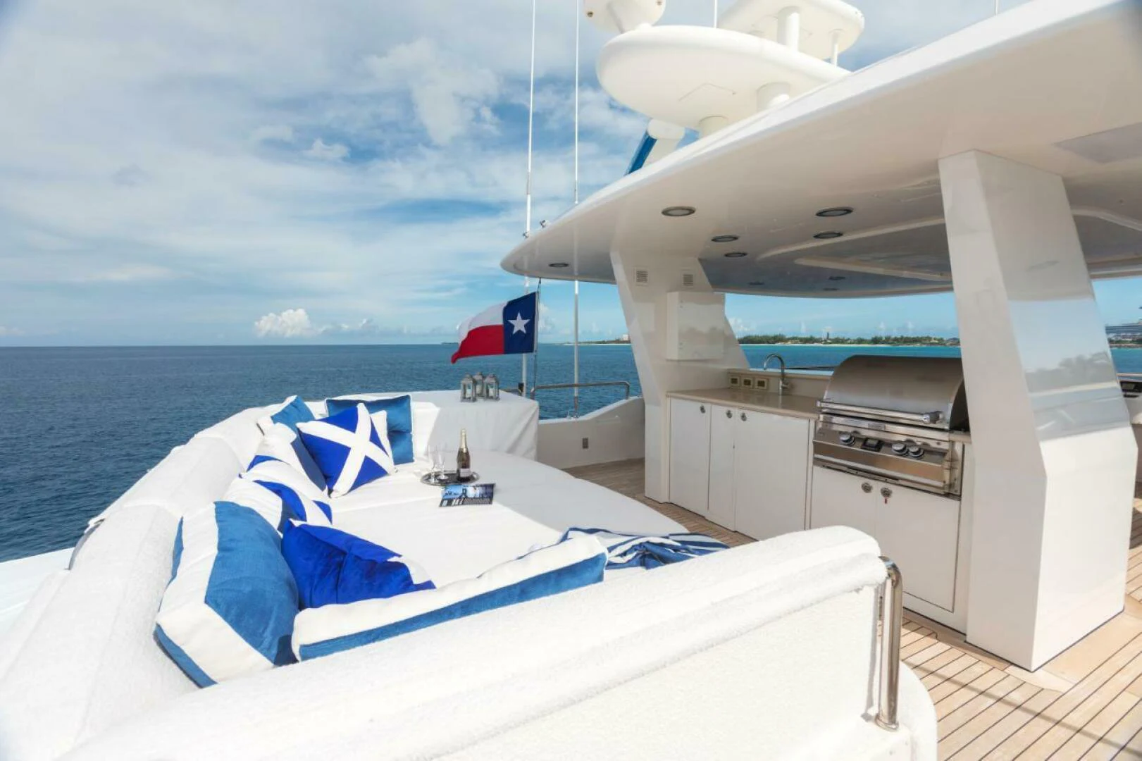 a boat with a flag on the deck aboard ALL INN Yacht for Sale