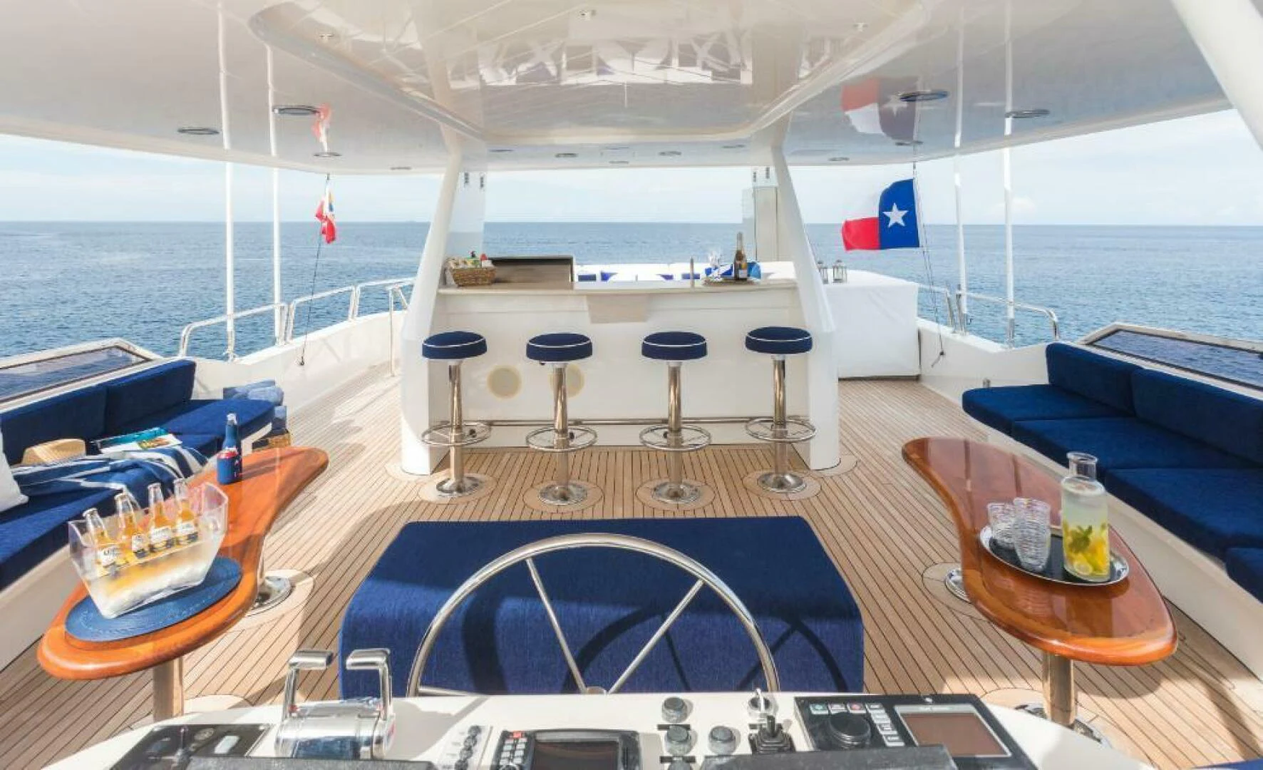 a boat with a table and chairs aboard ALL INN Yacht for Sale