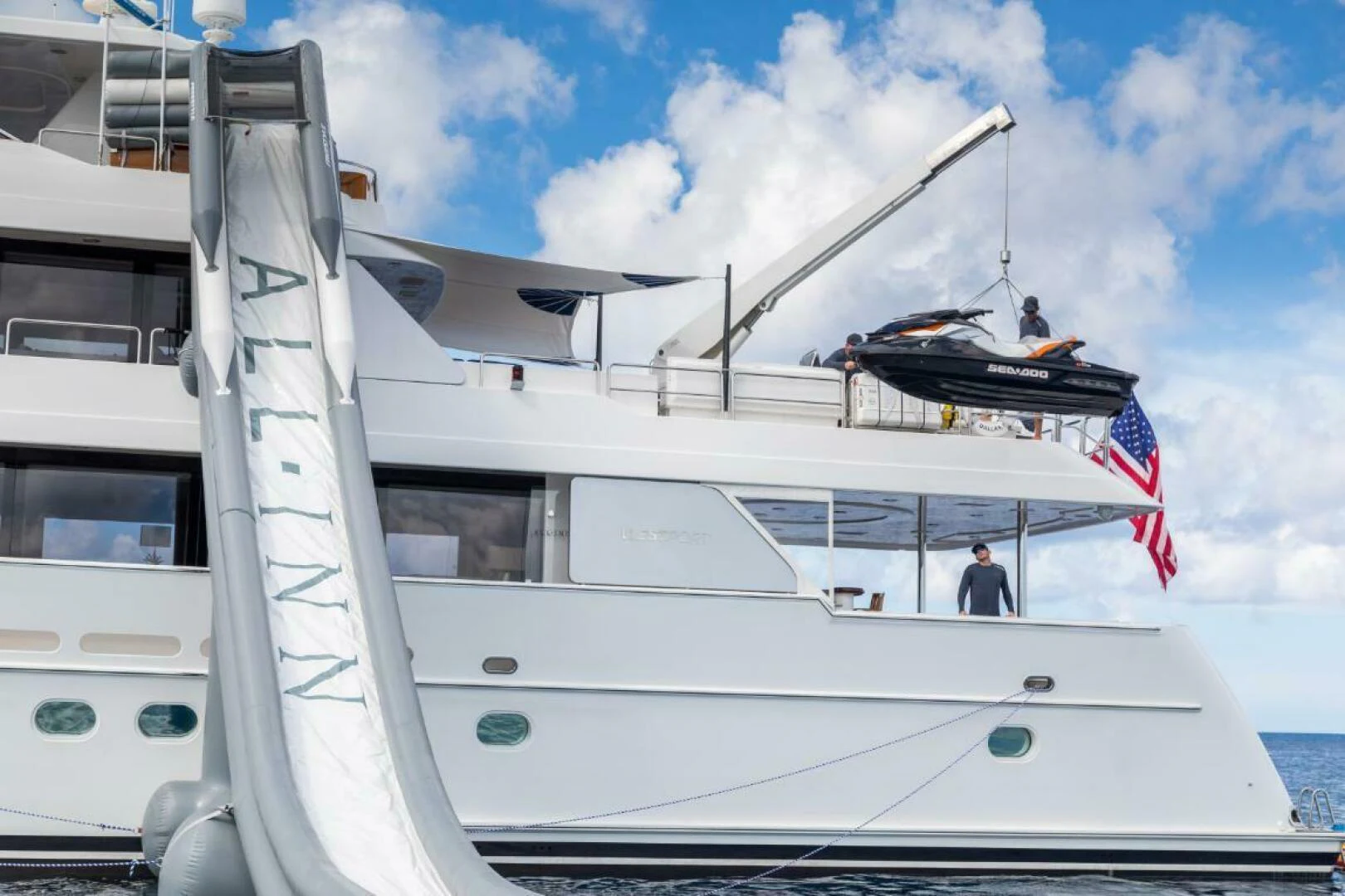 a boat with a flag on the front aboard ALL INN Yacht for Sale